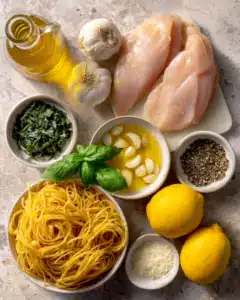 Chicken pasta with basil lemon and garlic ingredients in modern kitchen