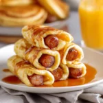 Fluffy breakfast pigs in a blanket with syrup drizzle