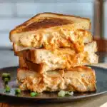 Buffalo Chicken Grilled Cheese cut in half with melty cheese