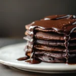Stack of chocolate pancakes with ganache
